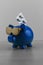 Cool blue piggy bank with golden glasses with pills on