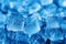 Cool and captivating, scattered ice cubes and water drops on blue