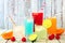 Cool colorful summer drinks against rustic wood
