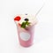 Cool delicious berry-flavored milkshake with whipped cream decorated with wild berries. Close-up, on a white background