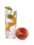 Cool drink with ice cubes and sliced peach