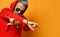 Cool elderly man with a gray beard and hair is standing with his arms crossed rock sign in red hoodie