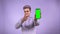 Cool female zoomer pointing chroma key green screen phone isolated