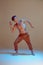 Cool flexible young man dancer dancing in neon light. Dance school poster. Dance lessons. Body with tattoos.