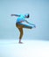 Cool flexible young man dancer dancing without shirt in neon blue light. Dance school poster. Dance lessons