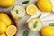 Cool freshly made lemonade and fruits on grey table, flat lay