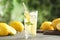 Cool freshly made lemonade and fruits on grey wooden table