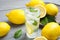 Cool freshly made lemonade and fruits on grey wooden table