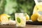 Cool freshly made lemonade and fruits on wooden table