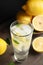 Cool freshly made lemonade and fruits on wooden table