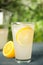 Cool freshly made lemonade in glass on blue table