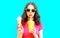 Cool girl drinks fruit juice from cup and holds ice cream