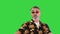 Cool grandfather in sunglasses dancing in a funny way on a Green Screen, Chroma Key.