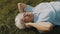 Cool grandma, woman with headphones lying on the grass and listening to the music