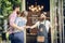 Cool hairstylist giving a fist bump to a happy customer at the door of a salon