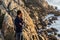 Cool Hispanic male with sunglasses on a rocky coast