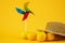 Cool image of lemons with hat and windmill spinner isolated on a yellow background