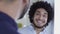 Cool looking middle eastern man with afro chatting in office