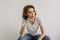 Cool looks woman in white t-shirt and jean relax in her apartment room.