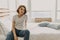 Cool looks woman in white t-shirt and jean relax in her apartment room.