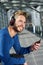 Cool man with beard smiling with headphones and mobile phone