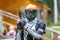 Cool paintball fighter in special armor holding paint handgun.