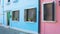 Cool panoramic view on cozy colorful houses with flowerpots in Burano, Venice