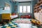 A cool pop art-inspired children\\\'s room with bright, flashy toys and retro furniture
