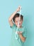 Cool, pretty boy plays with homemade slime in front of a blue background and is having a lot of fun