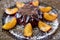 Cool purple jelly with fresh fruits and powder decorated with plums on dark plate on black wooden background close up