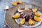 Cool purple jelly with fresh fruits and powder decorated with plums on dark plate close up. side view