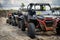 Cool quads stand in a row on sand before competition