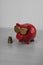 Cool red piggy bank with golden glasses with euro coins isolated
