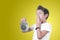 Cool school child boy with alarm clock. Kid holding alarm clock isolated on yellow . Time to go.