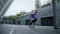 Cool skater making trick on skateboard outside. Sporty man jumping on longboard.