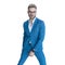 Cool unshaved man in elegant blue suit standing in a fashion position