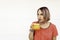 Cool woman drinks a glass of freshly squeezed orange juice during coronavirus outbreak - She drinks thirst-quenching orange juice