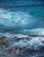 Cooled black lava beaten by the Atlantic ocean waves. View of sea waves hitting rocks on the beach. Waves and rocks.