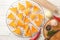 Cooling rack with corn chips and spices on white wooden table