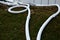 Cooling register of pipes under the ice surface. rows of frozen tubes. strong pipes, hoses are twisted on the lawn in the park. A