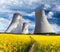 Cooling tower with golden flowering field of rapeseed