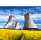 Cooling tower with golden flowering field of rapeseed