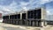 The cooling tower is located in a large data center building installed on the roof on a bright blue sky. And there are white