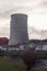 Cooling tower of a thermoelectric plant in the process of dismantling near a town