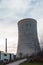 Cooling tower of a thermoelectric plant in the process of dismantling near a town