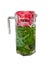 Cooling vitamin detox drink made from crushed mint leaves and currants in a large transparent glass jar with red cover isolated on