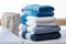 Coordinated comfort Stacked towels in blue, white, and gray showcase elegance