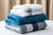 Coordinated comfort Stacked towels in blue, white, and gray showcase elegance