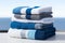 Coordinated comfort Stacked towels in blue, white, and gray showcase elegance