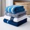 Coordinated comfort Stacked towels in blue, white, and gray showcase elegance